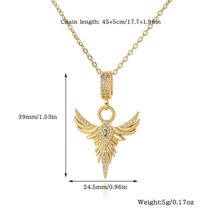 Detailed view of 18K gold wing pendant with green gemstones and precise measurements