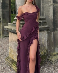 Detail of the elegant ruffled shoulder and high side slit on this purple evening gown