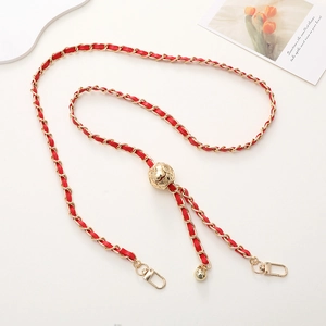 Detail of red woven leather strap with gold chain and spherical adjustment bead