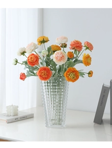 Detail of 3-head silk ranunculus in glass vase with textured finish for home decor