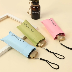 Mini portable UV protection folding umbrellas in pink, green, and blue with gold handles