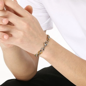 Macro view of 9mm two-tone gold and silver stainless steel Cuban link bracelet for men
