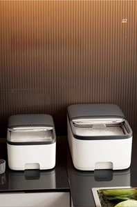 Detail of minimalist grain storage boxes in 5kg and 10kg sizes on a kitchen counter