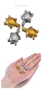 Detailed macro view of gold and silver sea turtle charms for DIY jewelry making