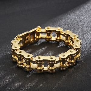 Detail of 18mm golden bike chain bracelet with heavy duty folding clasp on black background