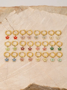 Matrix layout showing twelve pairs of gold floral earrings with colorful zirconia stones