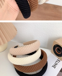 Close-up of thick knitted headband texture with non-slip lining and warm neutral colors