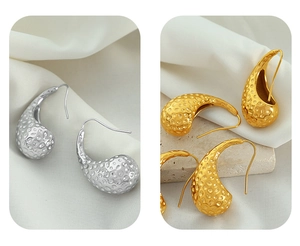 Detail view of 18K gold and silver waterdrop earrings with hammered metal texture