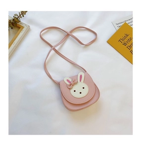 Detailed view of pink leather girls' crossbody bag with cute rabbit patch and bow detail