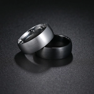 Macro view of 8mm wide brushed stainless steel rings in silver and matte black