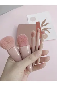 Close-up of pink 5-piece travel makeup brush set in matching storage case
