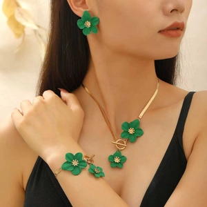 Detail of green flower jewelry set including necklace, earrings and bracelet on model
