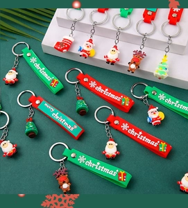 Close-up of colorful Christmas keychains with Santa and reindeer on a tiered display