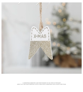 Detail of wooden star Christmas ornament with gold glitter and white X-MAS greeting text