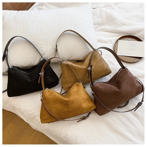 Flat lay of vintage suede shoulder bags in black, khaki, caramel, and dark brown colors