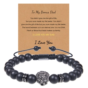 Detail view of lion head bracelet with black matte beads and bonus dad message card