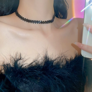 Detailed view of a multi-row black rhinestone choker necklace with sparkling accents