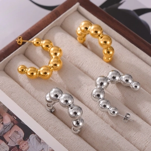 Gold and silver gradient bubble bead C-shaped titanium steel hoop earrings on display