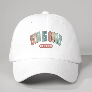 Detail shot of God is Good print on white adjustable cotton baseball cap with curved brim