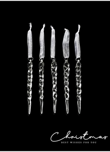 Close-up of five clear acrylic icicle ornaments with ribbons for Christmas tree decor