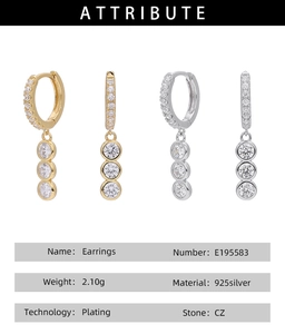 Macro detail of S925 silver hoop earrings with triple CZ stones in gold and silver plating