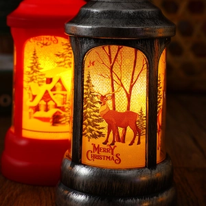 Close-up of vintage Christmas LED lanterns featuring warm reindeer and tree scenes.
