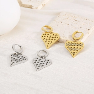Detailed view of hollow heart earrings with crystals in gold and silver finish