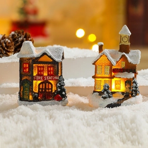 Luminous Christmas miniature village houses with warm LED lights and artificial snow decor