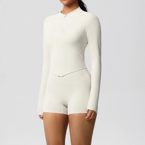 Close-up of off-white yoga set showing high-waisted shorts and zipper top texture