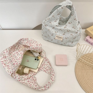 Floral canvas lunch bag showing internal storage for smartphones and cosmetics