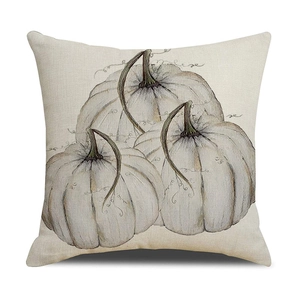 Close-up of linen pillowcase featuring three artistic white pumpkin illustrations for autumn