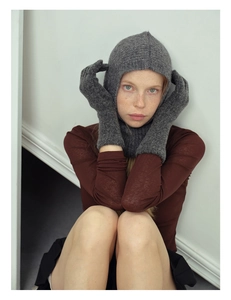 Close-up of grey wool blend knitted balaclava and warm gloves set on a model
