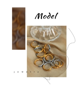 Detailed macro view of textured U-shaped earrings in two-tone gold and silver finishes