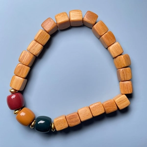 Detail view of sandalwood bamboo-joint beads with lotus charms and colorful resin spacers