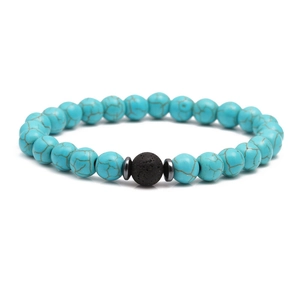 Detail of blue turquoise beads bracelet with a black volcanic lava stone and metal spacers