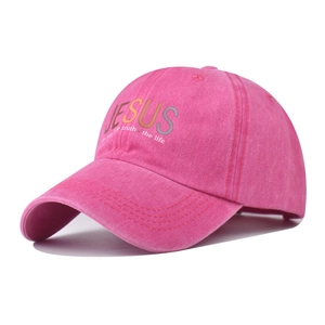Detail shot of the embroidery on a rose pink washed cotton Jesus baseball cap