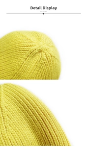 Detailed close-up of bright yellow knitted beanie showing top stitching and thick texture