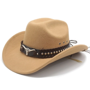 Detail of camel western cowboy hat featuring silver bull horn metal emblem and studded band