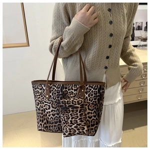 Detail shot of leopard print tote bag set featuring a matching small zipper pouch