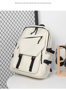 Detail of white large capacity laptop backpack with black buckles and multi-pocket design