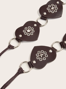 Detail of dark brown Y2K belt featuring heart leather patches and star studs metal rings