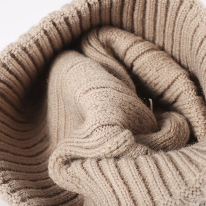 Women's warm ribbed knit beanie in camel brown showing thick premium texture