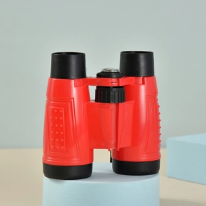 Close-up of 6X30 kids binoculars in red and black with an integrated compass on top