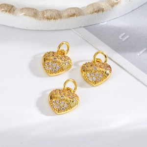 Detailed view of three gold heart pendants with rhinestones and MOM engraving