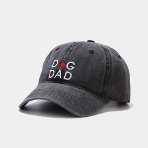 Detail of Dog Dad embroidery and paw print on washed black vintage cotton baseball cap