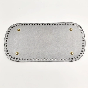 Silver oval PU leather bag base detail with pre-punched holes and four gold metal feet