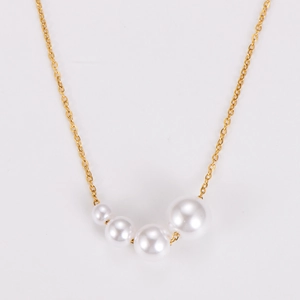 Detailed view of elegant gold necklace featuring gradient white pearls on thin chain
