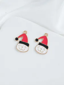 Detail view of two enamel cat charms with red Christmas hats for DIY jewelry