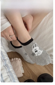 Detailed view of grey rabbit socks showing high elasticity and ribbed cuff comfort