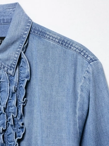 Detailed close-up of ruffled standing collar and shoulder stitching on blue denim shirt